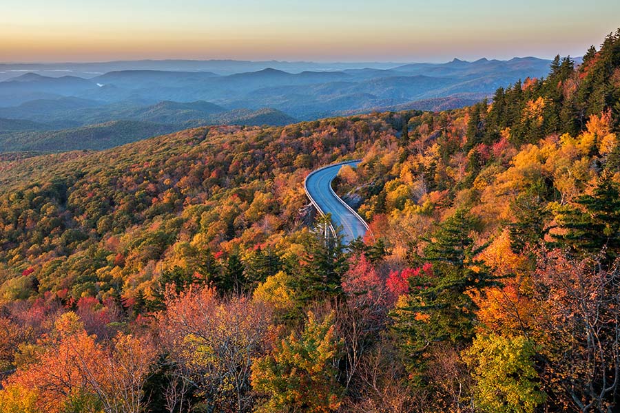 About Our Agency - Aerial View of the Blue Ridge Parkway in North Carolina Displaying Many Fall-Colored Trees and Valleys
